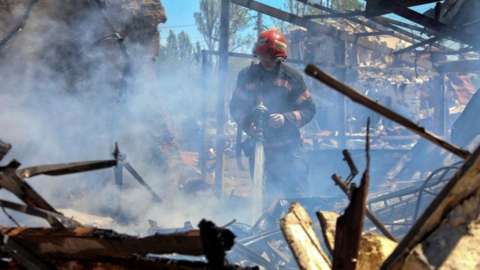 A Ukrainian firefighter works at the site of alleged Russian missile strikes in the resort of Zatoka, southern Odesa region. Photo: 26 July 2022