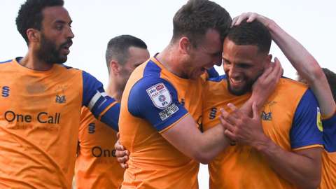 Mansfield Town took a major step toward their first play-off final for 18 years with a dominant 2-0 semi-final first-leg victory against Northampton.
