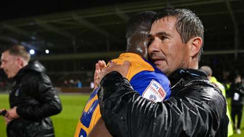 Manager Nigel Clough celebrates with one of his players