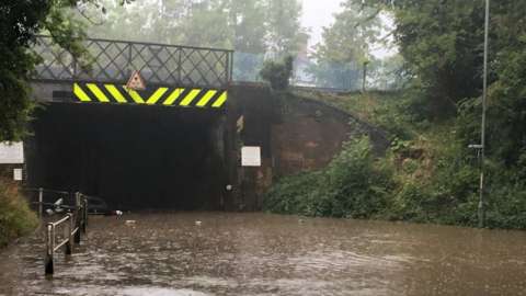 Flooded road under a bridge