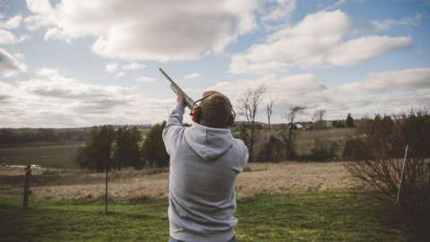 Man doing clay pigeon shooting