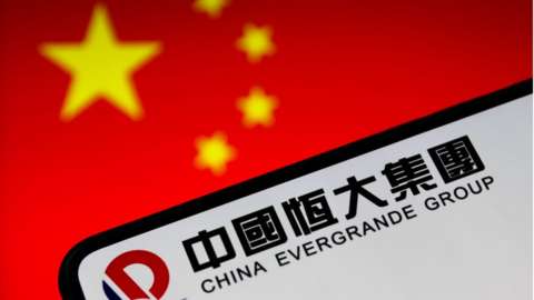 The evergrande logo is seen in front of a Chinese flag