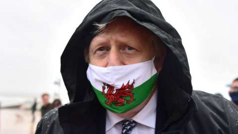 Boris Johnson wearing a Welsh flag face mask