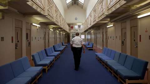 A female prison officer walks through the communal area inside HM Prison Styal in Cheshire