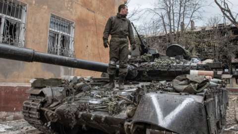 A Russian soldier standing on a T-80 tank in Mariupol in April