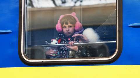 A child looks out the window of a train as it arrives in Lviv from Zaporizhzhia on 5 April 2022