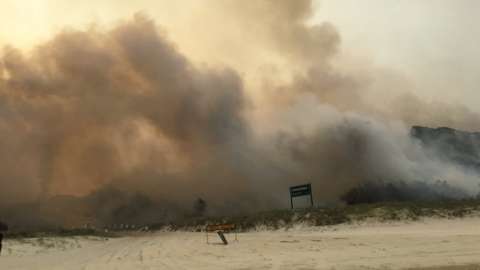 Smoke from a massive bushfire on Fraser Island seen at Cathedral Beach on 6 December 2020