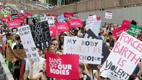 Protesters carrying signs in support of abortion rights