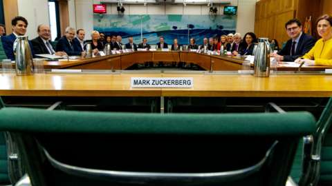 A meeting of the DCMS committee empty-chairing Mark Zuckerberg