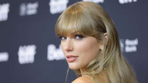 Taylor Swift on Red carpet gazing at camera