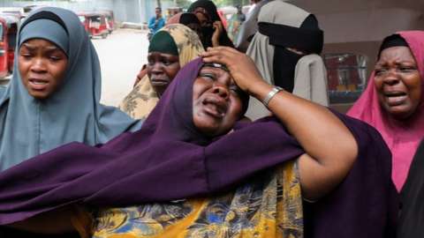 A woman reacts after receiving the confirmation that her son was killed in a suicide bombing attack on a military base, at the Madina Hospital in Mogadishu
