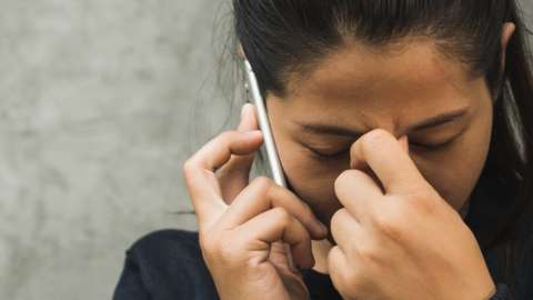 stock photo of an upset woman making a phone call