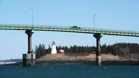 Cars cross the International Bridge between Lubec, Maine (L) and Campobello Island, Canada