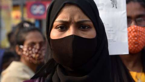Activists hold placards and march during a demonstration in Kolkata, on 16 February 2022 after students at government-run high schools in India's Karnataka state were told not to wear hijabs to class.