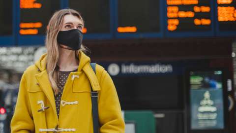 A passenger waits for a train