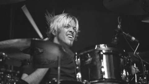 Drummer Taylor Hawkins is shown performing on stage during a "live" concert appearance with the Foo Fighters on 2 April 2000.