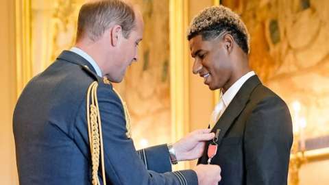 Marcus Rashford being made an MBE by Prince William