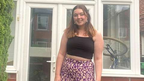 Jess Walmsley outside her rented house in Manchester