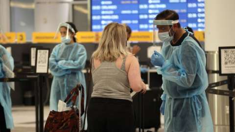 Healthcare workers speaking to a traveller in Canada