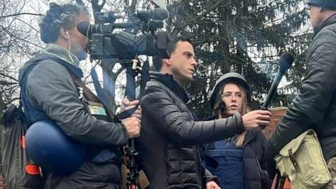 Fox News cameraman Pierre Zakrzewski (left) and journalist Oleksandra "Sasha" Kuvshynova (centre-right) filming an interview in Ukraine