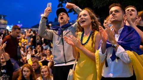 Ukrainian supporters react as they watch the UEFA EURO 2020, 1/8 of final football match between Sweden and the Ukraine on a giant screen at the fanzone in the center of Kiev on June 29, 2021.