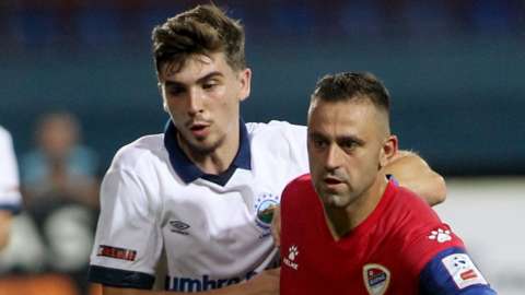 Cammy Palmer challenges for the ball