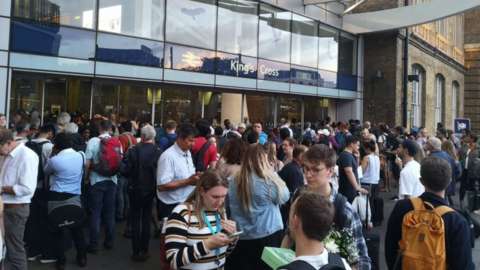 Passengers queue outside King's Cross station