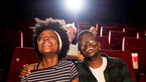 Couple laughing at the cinema