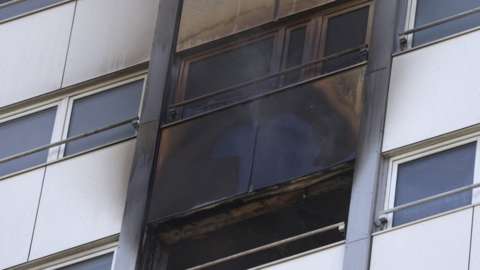 The scorched windows of the flat from outside aerial footage
