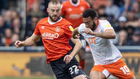Blackpool's Keshi Anderson competing with Luton Town's Allan Campbell during the Championship match between Luton Town and Blackpool at Kenilworth Road