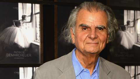 Patrick Demarchelier in front of some of his photos