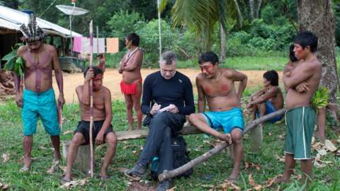 Dom Phillips taking notes as he speaks with indigenous people in Roraima State, Brazil in 2019