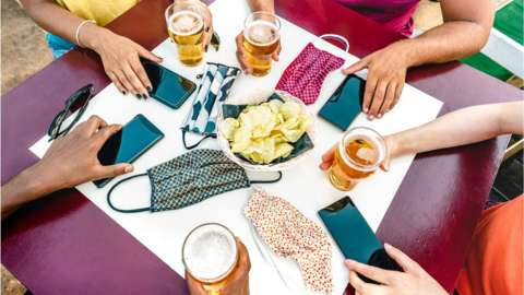phones, masks and drinks on table