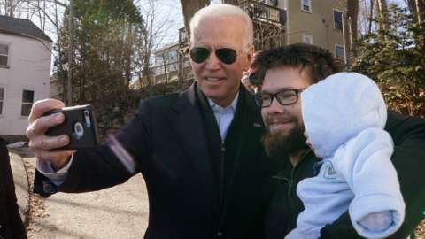 Democratic presidential candidate and former Vice President Joe Biden greets a man with his baby after a campaign event in Somersworth, New Hampshire, U.S., February 5, 2020