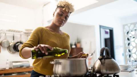 A woman cooking in a kitchen