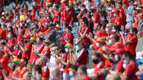 Wales fans cheer in the crowd during the international friendly football match between Wales and Albania at Cardiff City Stadium in Cardiff, South Wales, on June 5, 2021. (Photo by Geoff Caddick / AFP) (Photo by GEOFF CADDICK/AFP via Getty Images)