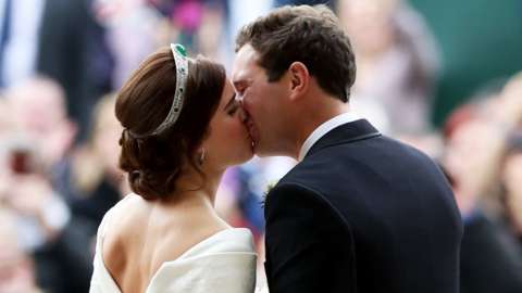 Princess Eugenie and her new husband Jack Brooksbank kiss as they leave St George"s Chapel in Windsor Castle following their wedding