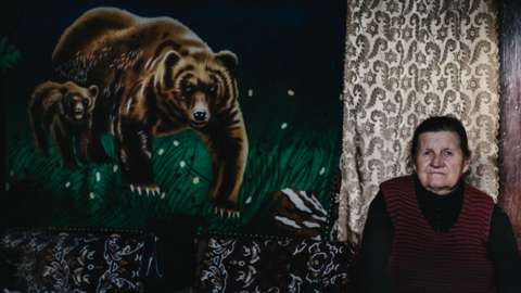 Woman with painting of a bear
