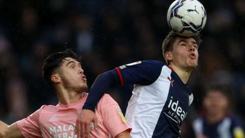 Ryan Giles Cardiff City fights for the ball with Tom Fellows of West Bromwich Albion in an aerial challenge