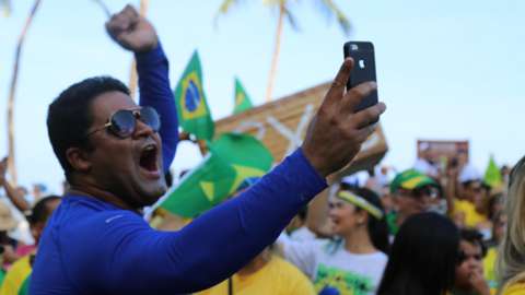 A supporter of Jair Bolsonaro takes a selfie at a rally