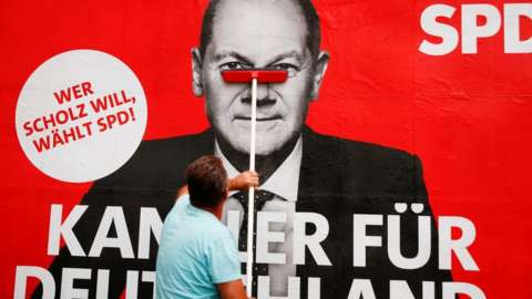 A placard of Olaf Scholz, candidate for Chancellor of Germanyâ€™s Social Democratic party SPD is placed on a board for the September 26 German general elections in Bonn, Germany, September 20, 2021