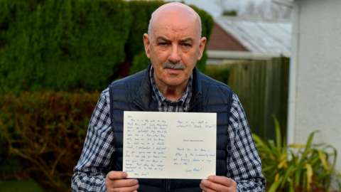 Shopkeeper Jim Barr holds an anonymous letter of apology from somone who says they stole from his shop thrity years ago