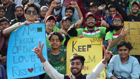 Pakistan fans cheer on their team and hold up sign during the second Test against England