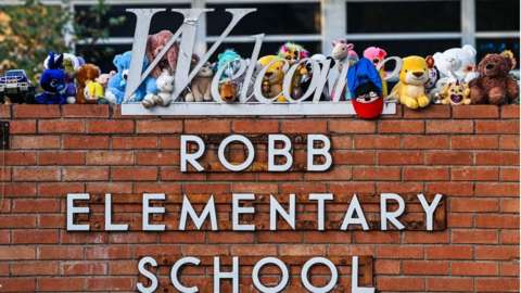 Mementos decorate a makeshift memorial for the shooting victims outside Robb Elementary School in Uvalde, Texas