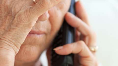 stock image of an elderly person on the phone