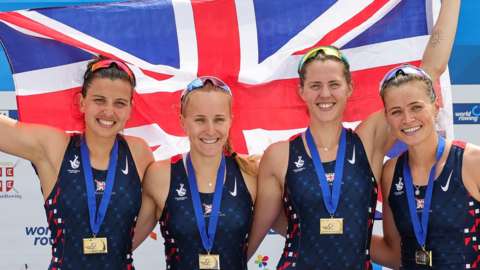 England's W4 gold medal winners pose with a union jack and their medals