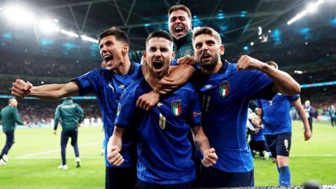 Italy's Jorginho with teammates celebrate after winning the penalty shoot-out