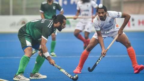 Pakistan's Ali Shan (L) and India's Gursahibjit Singh (R) fight for the ball during the men's field hockey third place match between India and Pakistan at the Asian Championship Trophy tournament in Dhaka on December 22, 2021