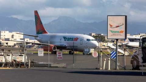 A Transair 737 cargo plane on the runway in Hawaii