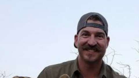 Blake Fischer posing in Africa above a kill